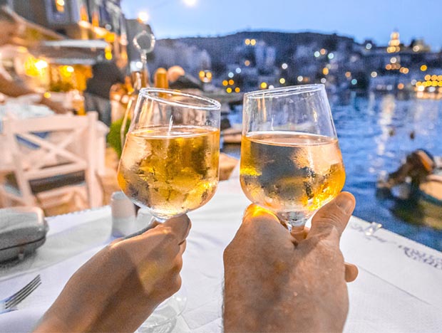 Greek Islands- Raising wine galsses Greek Islands- Raising wine glasses